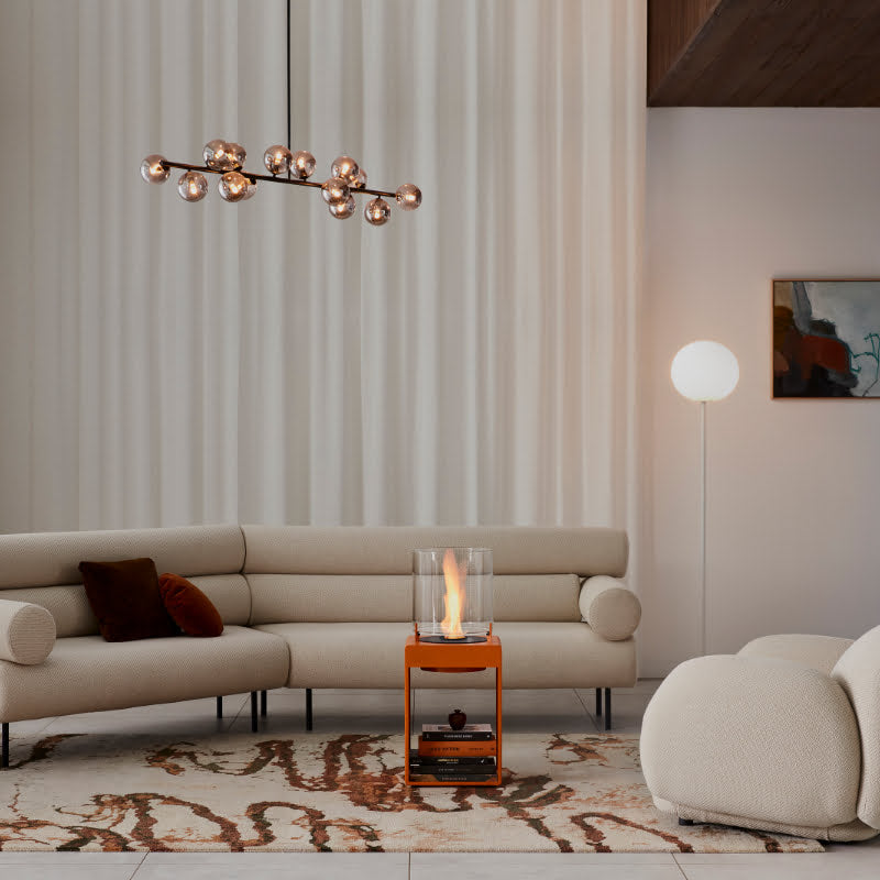 Pop 3T Tall Ethanol Fireplace orange in luxury living room